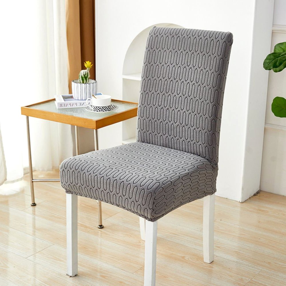 Velvet Haven Elastic Jacquard Chair Cover in Charcoal Gray with Ripple Loop pattern, showcasing its stretch fit on a dining chair. Offers modern design furniture protection.