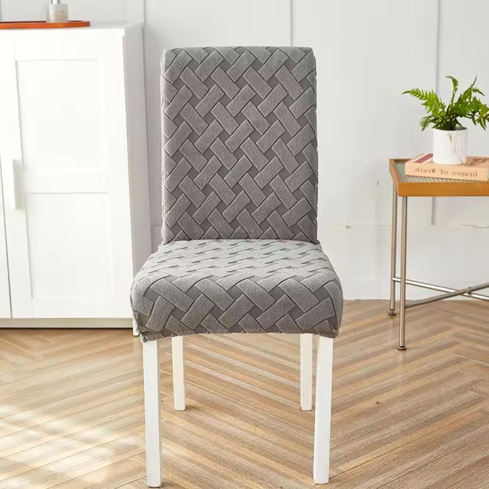 Haven Weave Jacquard Chair Cover in Charcoal Gray, highlighting its elegant woven pattern on a dining chair in a home setting.