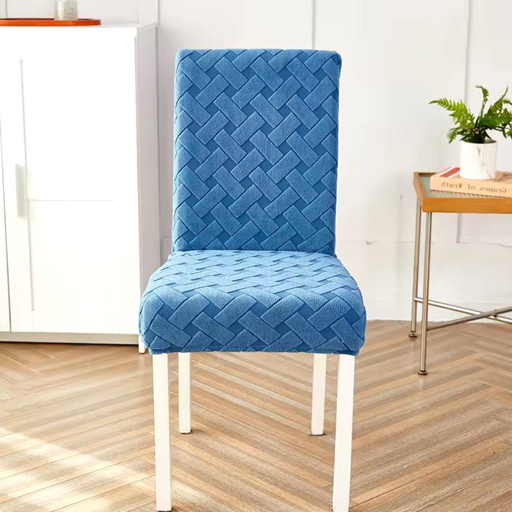 Haven Weave Jacquard Chair Cover in Deep Ocean Blue, featuring an elegant woven pattern, fitted on a dining chair in a modern living space.