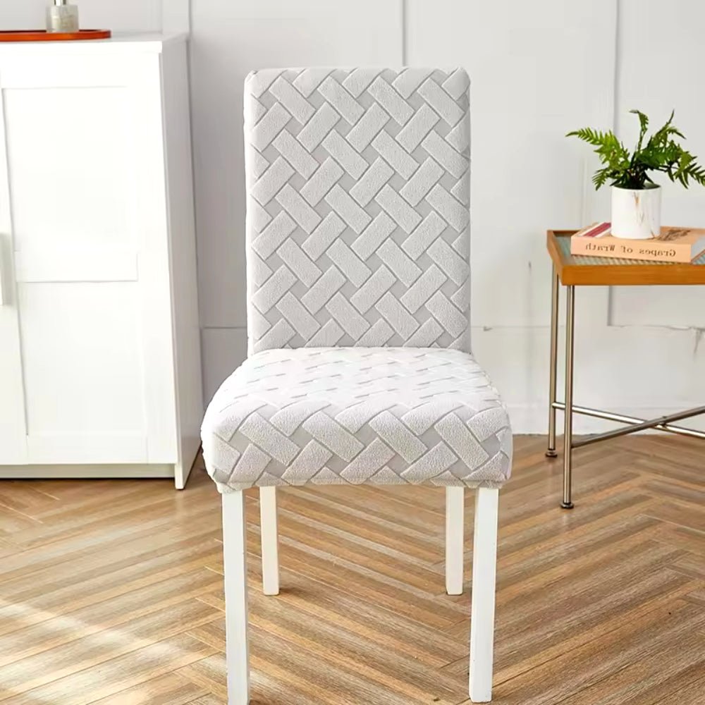Haven Weave Jacquard Chair Cover in Frosted Silver, displaying its elegant woven pattern on a dining chair in a home setting.