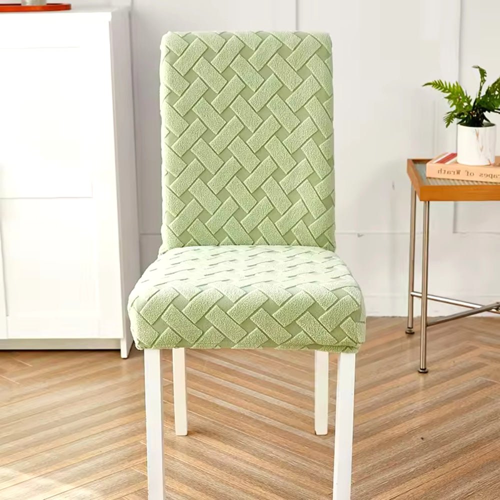 Haven Weave Jacquard Chair Cover in Soft Sage Green, showcasing its elegant woven pattern on a dining chair in a home setting.