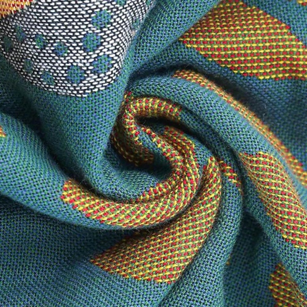 Close-up of Nordic Nest cotton gauze pillowcase fabric, showing soft texture with teal, yellow, red, and white woven patterns. Highlights the breathable and cozy material.