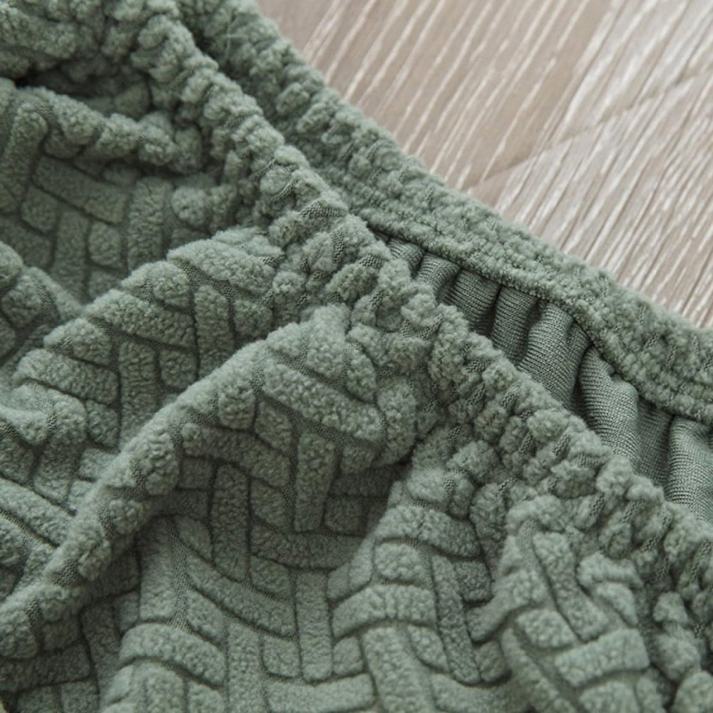 Detailed close-up of the elasticized edge of the olive green Veluxe Haven Jacquard Velvet Dining Chair Cover, showcasing its stretch-fit design and soft, textured fabric.