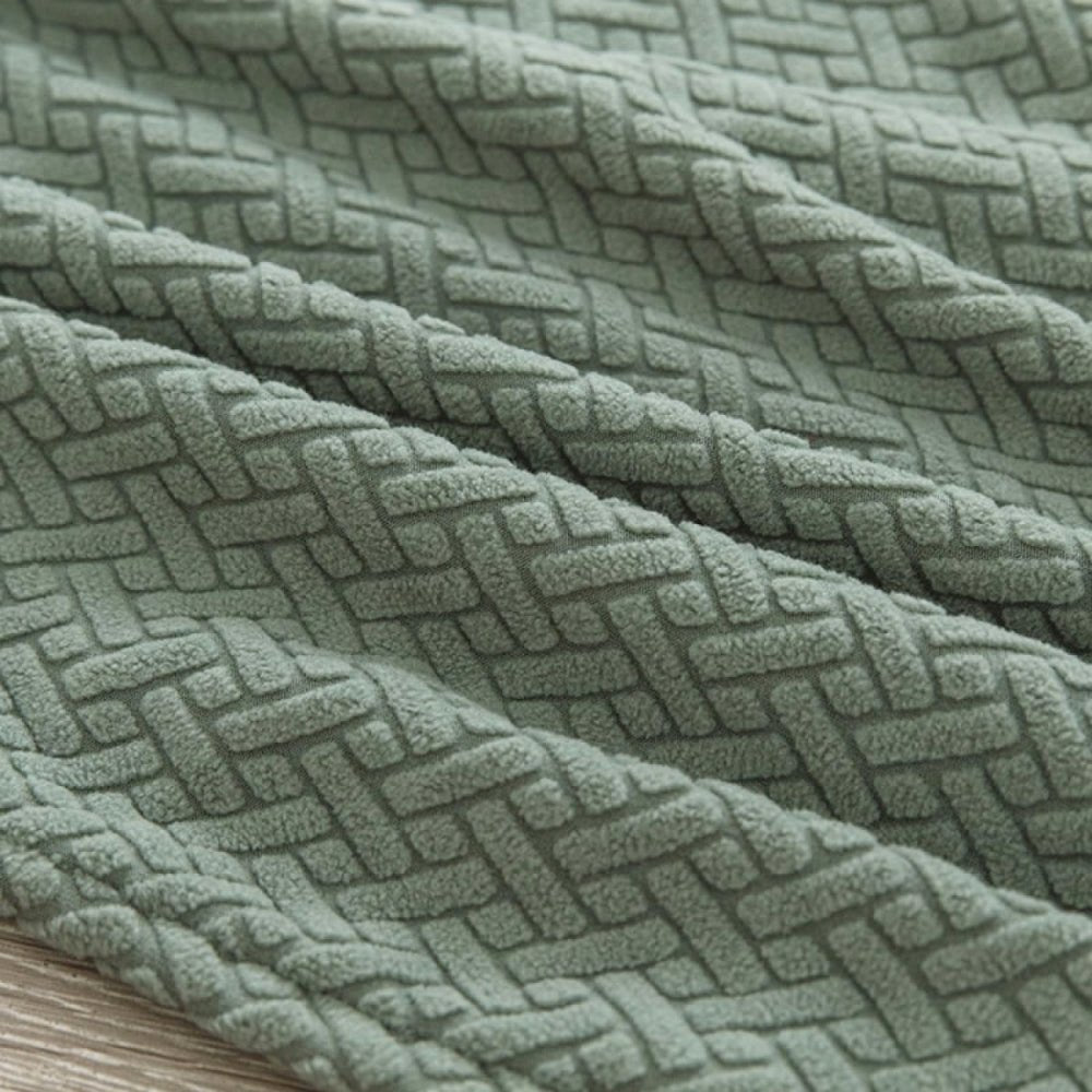 Close-up view of the olive green Veluxe Haven Jacquard Velvet Dining Chair Cover, highlighting its textured, stretch-fit fabric and intricate pattern.