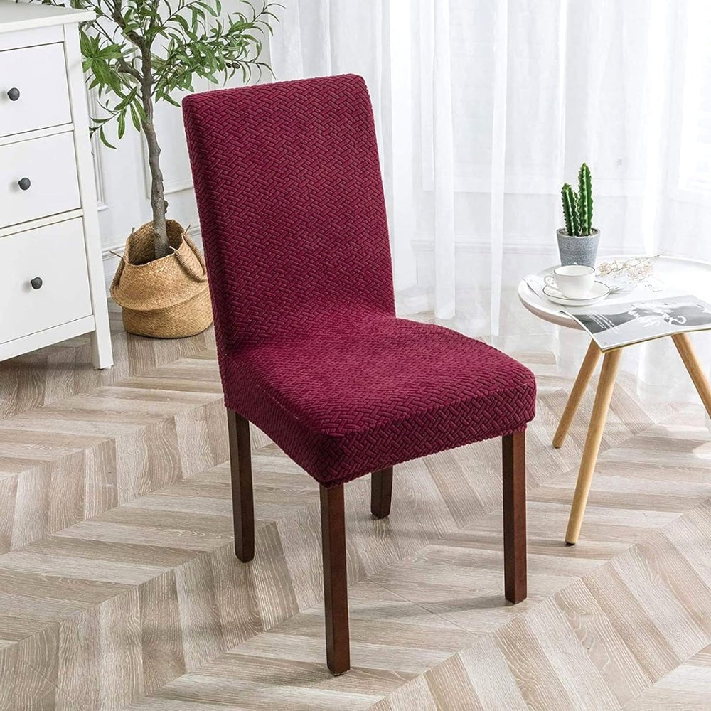 Wine Red Veluxe Haven Jacquard Velvet Dining Chair Cover with Stretch Fit, highlighting its rich color and textured fabric on a dining chair in a contemporary interior.
