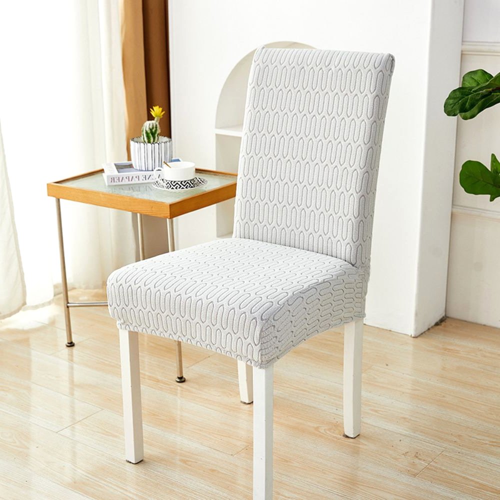 Soft White Ripple Loop Elastic Jacquard Chair Cover on a dining chair, showcasing its stretch fit and modern design in a home setting.