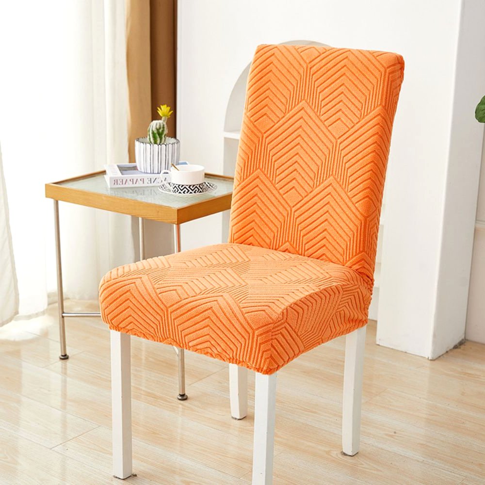 Velvet Haven Elastic Jacquard Chair Cover in Sunset Orange with Chevron Maze pattern, showcasing its stretch fit on a dining chair. Perfect adding vibrant touch home decor.