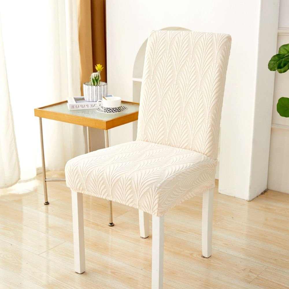Velvet Haven Elastic Jacquard Chair Cover in Warm Beige Palm Weave pattern, shown on a white dining chair. This stretch fit furniture protector offers a modern design and easy installation.